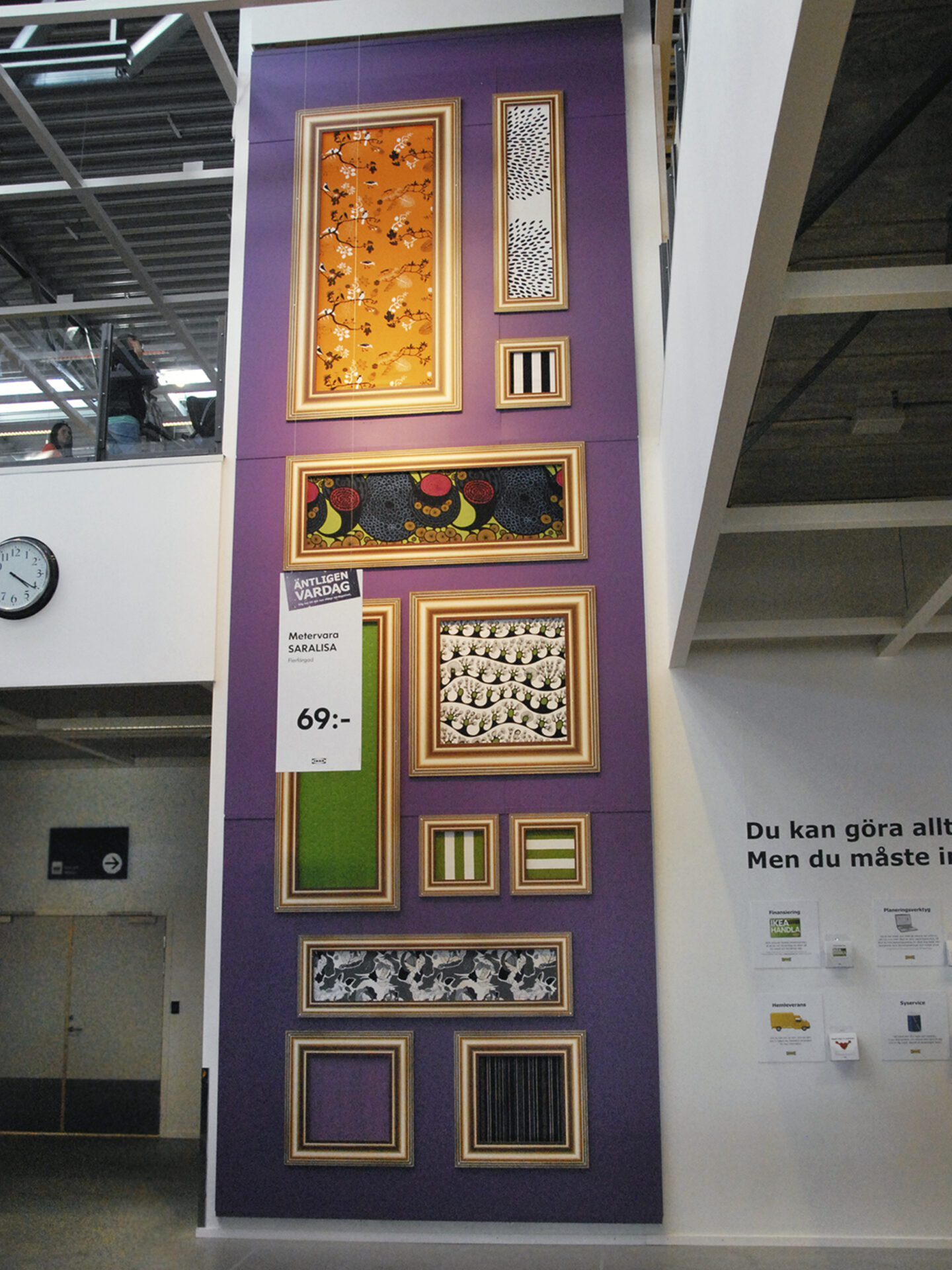 A wall with textiles in golden picture frames